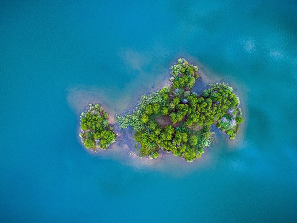 Drone picture of a small, green island